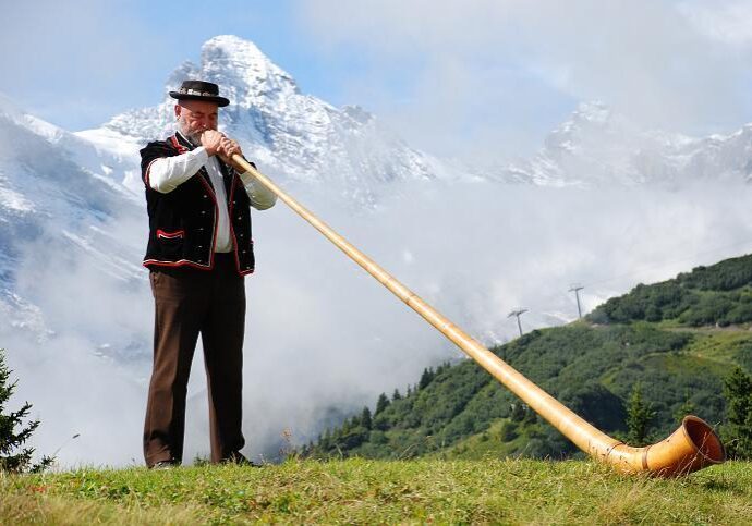 Male in mountains with trumpet