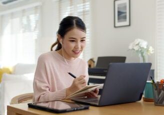 Young lady studying on laptop